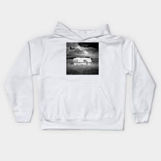 an abandoned caravan in an idyllic pasture Kids Hoodie